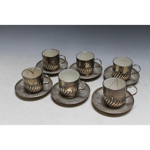 369 - A SET OF SIX HALLMARKED SILVER COFFEE CUPS AND SAUCERS BY WILLIAM HUTTON & SONS LTD - LONDON 1905, a... 