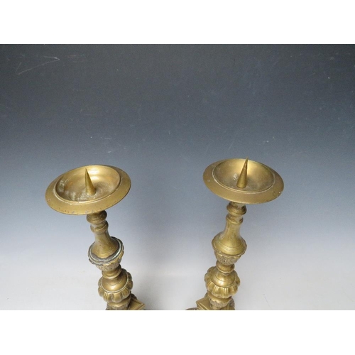 402 - A PAIR OF DECORATIVE BRASS PRICKET CANDLESTICKS, with cherubic mask detail, H 43 cm (2)