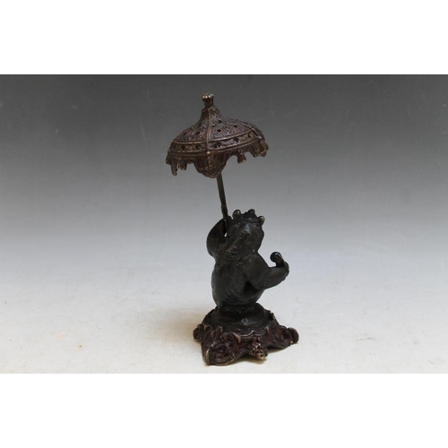 414 - A BRONZE STYLE FIGURE OF A BEAR HOLDING A PARASOL, H 20 cm