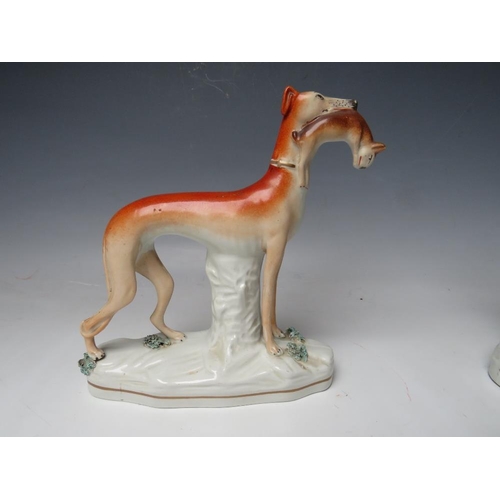 443 - A PAIR OF 19TH CENTURY STAFFORDSHIRE GREYHOUNDS WITH HARES IN THEIR MOUTHS, H 19 cm (2)