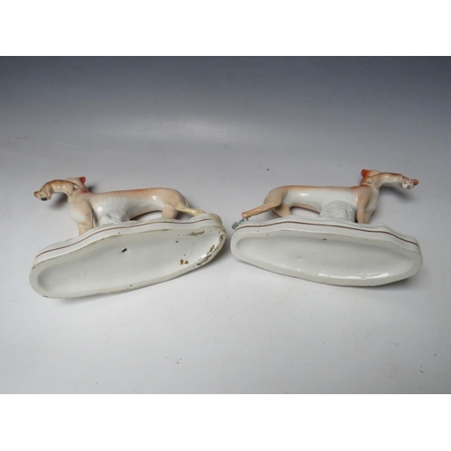 443 - A PAIR OF 19TH CENTURY STAFFORDSHIRE GREYHOUNDS WITH HARES IN THEIR MOUTHS, H 19 cm (2)