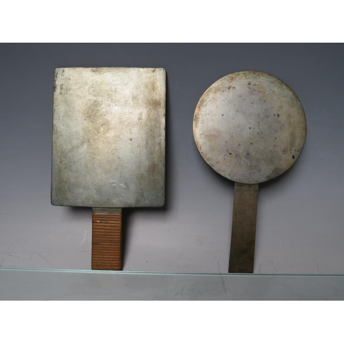 463 - TWO BRONZE JAPANESE HAND MIRRORS. together with three decorated bronze plates and a bronze relief po... 