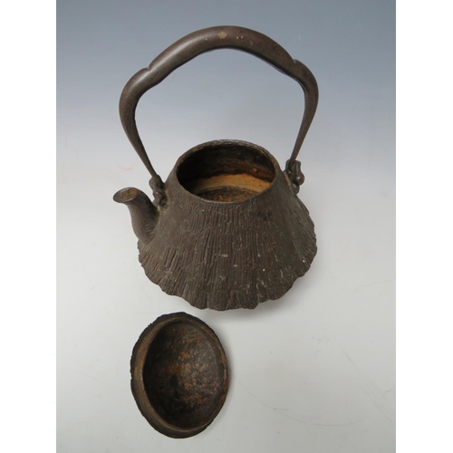 467 - A 20TH CENTURY CAST IRON JAPANESE TEAPOT, together with a brass lozenge shaped casket, the teapot ha... 