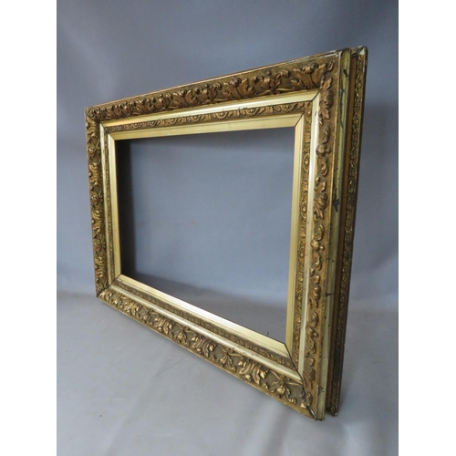 47 - A 19TH CENTURY GOLD FRAME WITH LEAF DESIGN AND INTEGRAL GOLD SLIP, frame W 11 cm, rebate 65 x 45 cm