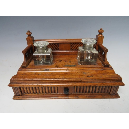 474 - A SMALL DECORATIVE WOODEN DESK STAND WITH SINGLE DRAWER BELOW, complete with two fitted ink bottles ... 