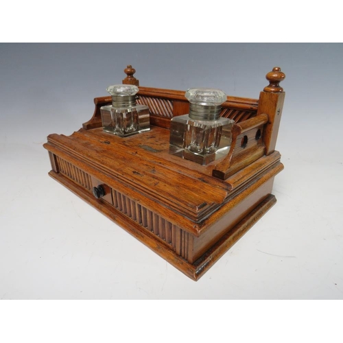 474 - A SMALL DECORATIVE WOODEN DESK STAND WITH SINGLE DRAWER BELOW, complete with two fitted ink bottles ... 