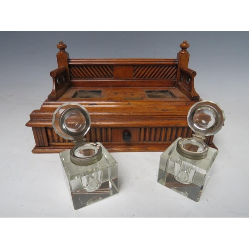 474 - A SMALL DECORATIVE WOODEN DESK STAND WITH SINGLE DRAWER BELOW, complete with two fitted ink bottles ... 