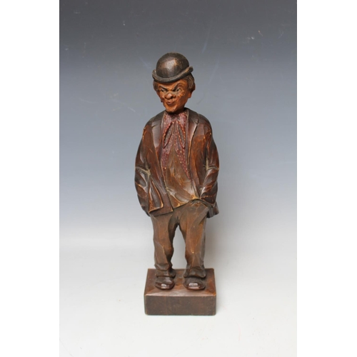 479 - A BLACK FOREST CARVED SOFTWOOD 'WHISTLING FIGURE', circa 1930, in the form of a man with his hands i... 