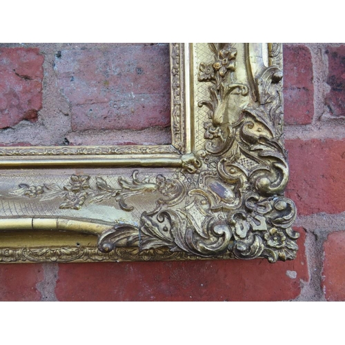 50 - A 19TH CENTURY DECORATIVE GOLD SWEPT FRAME, frame W 10 cm, rebate 54 x 36 cm