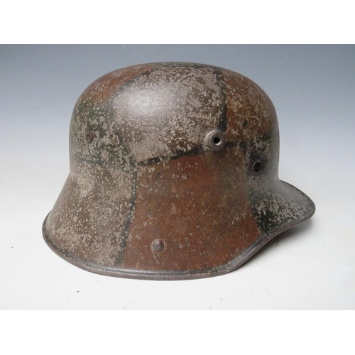 506 - A GERMAN M16 CAMOUFLAGE HELMET, complete with internal webbing