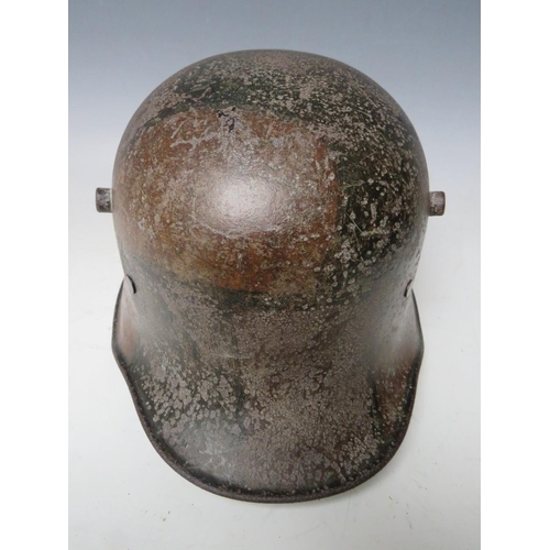 506 - A GERMAN M16 CAMOUFLAGE HELMET, complete with internal webbing