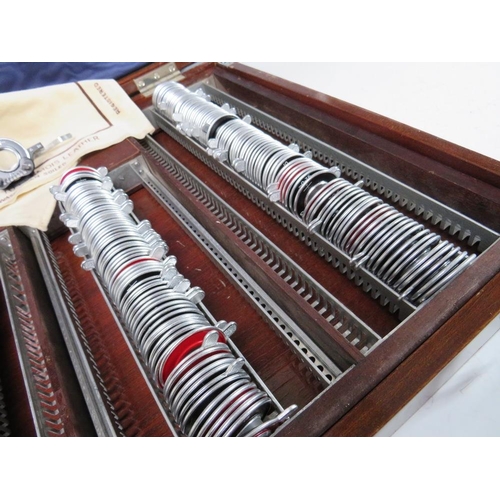 519 - A LARGE OPTICIANS TRIAL LENS SET WITH CLEMENT CLARKE HOLDER, in mahogany case