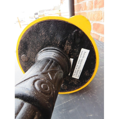 521 - A VINTAGE AMERICAN GUMBALL MACHINE ON CAST IRON BASE, with yellow painted alloy body and glass globe... 