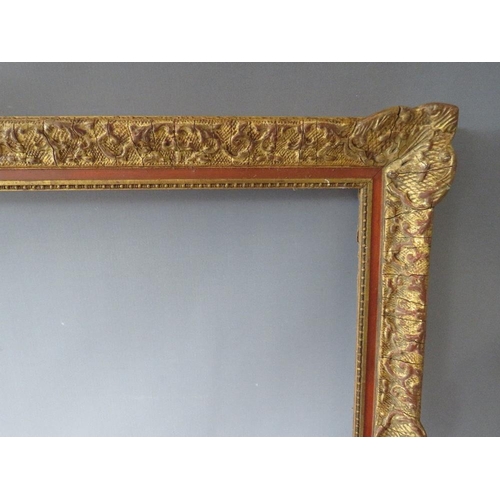 53 - A 19TH CENTURY DECORATIVE GOLD SWEPT FRAME, frame W 6.5 cm, rebate 74 x 54 cm