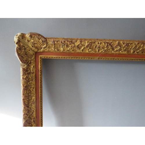 53 - A 19TH CENTURY DECORATIVE GOLD SWEPT FRAME, frame W 6.5 cm, rebate 74 x 54 cm