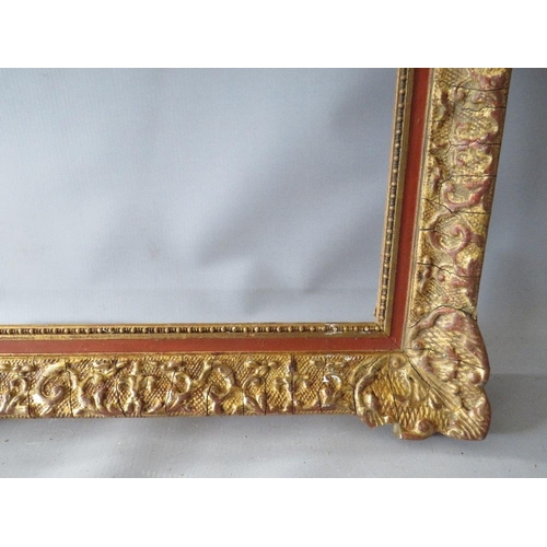 53 - A 19TH CENTURY DECORATIVE GOLD SWEPT FRAME, frame W 6.5 cm, rebate 74 x 54 cm