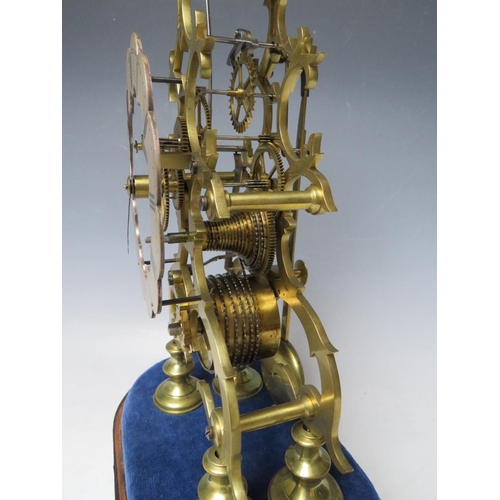 555 - A GOOD QUALITY BELL STRIKE SKELETON CLOCK WITH GLASS DOME, the hand cut brass frame having a silvere... 