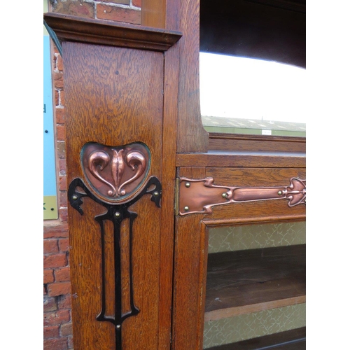 567 - AN EARLY 20TH CENTURY ARTS AND CRAFTS CABINET, having typical copper stylised mounts to the front, w... 