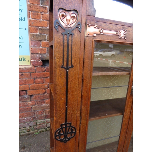 567 - AN EARLY 20TH CENTURY ARTS AND CRAFTS CABINET, having typical copper stylised mounts to the front, w... 