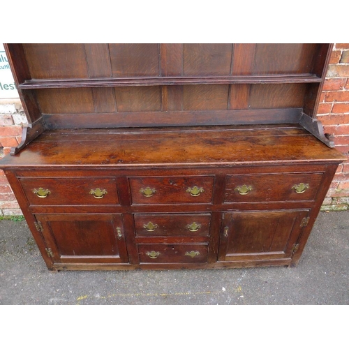 568 - AN 18TH CENTURY OAK WELSH DRESSER, the base with an arrangement of five drawers and two cupboards, a... 