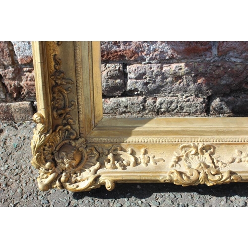 57 - AN 18TH CENTURY DECORATIVE GOLD SWEPT FRAME WITH GOLD SLIP, frame W 8.5 cm, 26 x 36 cm