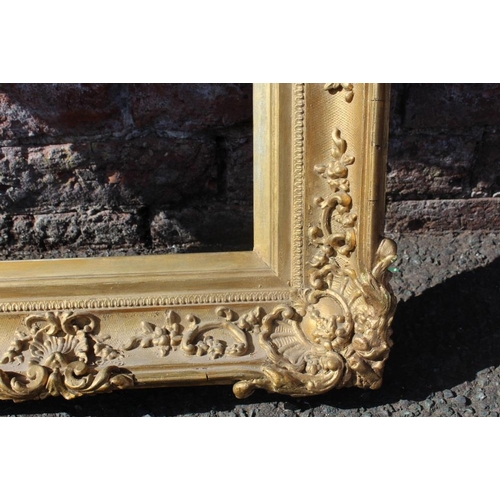 57 - AN 18TH CENTURY DECORATIVE GOLD SWEPT FRAME WITH GOLD SLIP, frame W 8.5 cm, 26 x 36 cm