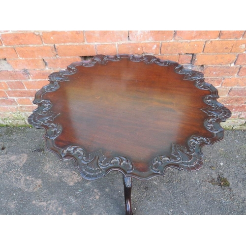 570 - AN ANTIQUE MAHOGANY 'BIRDCAGE' PEDESTAL TABLE, the shaped top with carved detail, raised on a carved... 