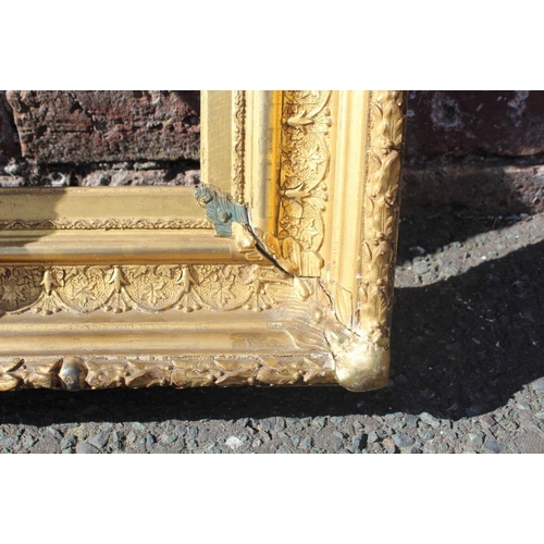 58 - AN 18TH CENTURY CONTINENTAL DECORATIVE GOLD FRAME, with acanthus leaf design to outer edge, frame W ... 