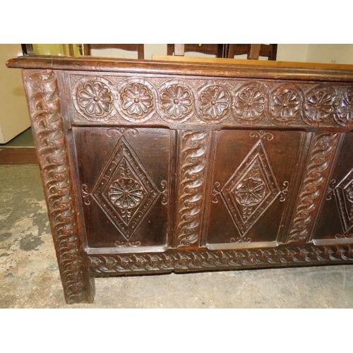 581 - AN 18TH CENTURY OAK PANELLED AND CARVED COFFER, H 73 cm, W 153 cm