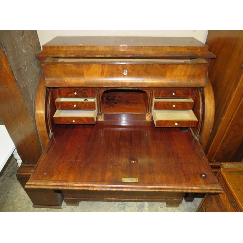 584 - A 19TH CENTURY BIEDERMEIER STYLE MAHOGANY CYLINDER BUREAU HAVING A FITTED INTERIOR,  the pull-out wr... 