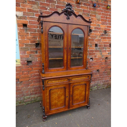 587 - A 19TH CENTURY WALNUT GLAZED BOOKCASE, the upper section with twin glazed doors and carved moulded d... 