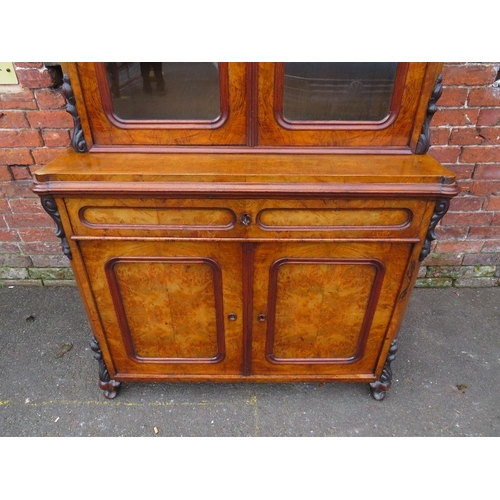 587 - A 19TH CENTURY WALNUT GLAZED BOOKCASE, the upper section with twin glazed doors and carved moulded d... 