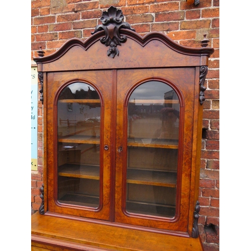 587 - A 19TH CENTURY WALNUT GLAZED BOOKCASE, the upper section with twin glazed doors and carved moulded d... 