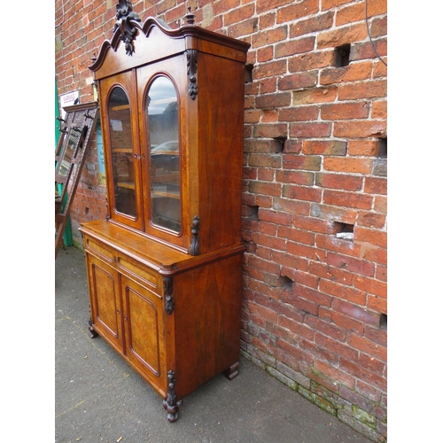 587 - A 19TH CENTURY WALNUT GLAZED BOOKCASE, the upper section with twin glazed doors and carved moulded d... 