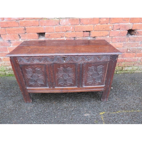 595 - AN EARLY CARVED OAK THREE PANEL COFFER, raised on stile feet, H 62 cm, W 104 cm