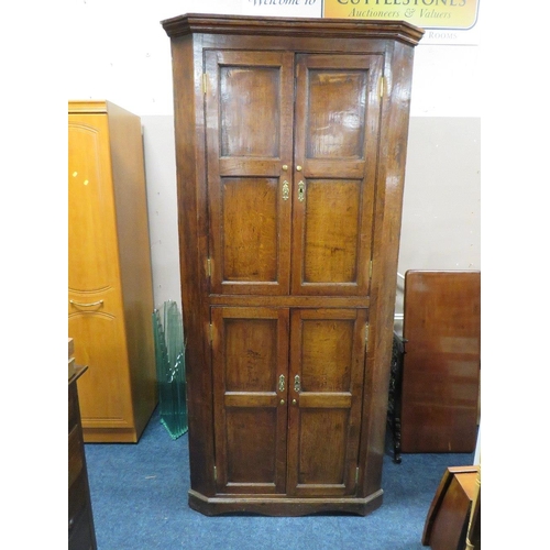 603 - A 19TH CENTURY OAK FLOORSTANDING CORNER CUPBOARD, with four panelled doors, H 210 cm, W 94 cm