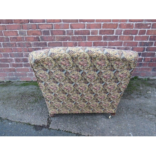 607 - A LARGE UPHOLSTERED OPEN ARMCHAIR, in the style of Howard & Sons, the back leg stamped '4470 4072'