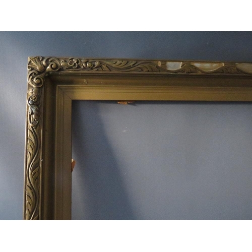 64 - AN EARLY 20TH CENTURY GOLD FRAME WITH LEAF DESIGN TO OUTER EDGE, frame W 8.5 cm, rebate 92 x 61 cm, ... 