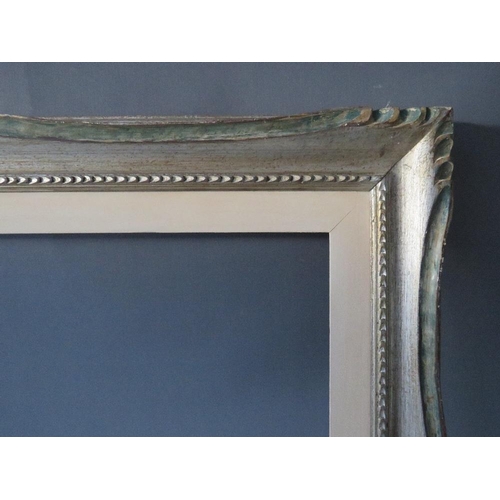 65 - A 20TH CENTURY CARVED WOODEN SILVERED FRAME WITH PAINTED SLIP, frame W 8 cm, slip rebate 80 x 60 cm,... 