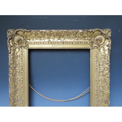 78 - AN 18TH CENTURY DECORATIVE GOLD FRAME WITH CORNER EMBELLISHMENTS, frame W 10 cm, frame rebate 47 x 3... 