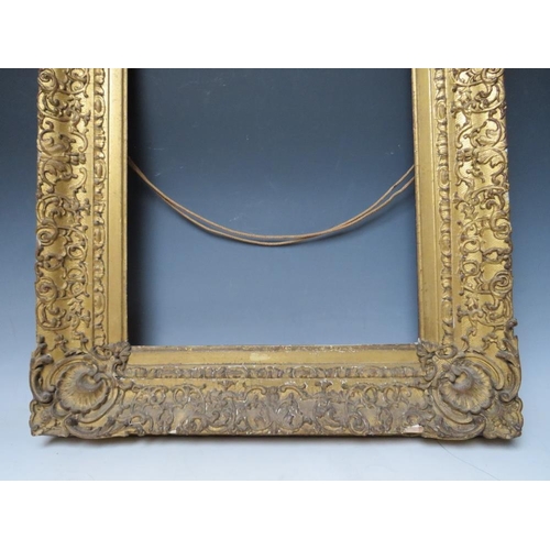 78 - AN 18TH CENTURY DECORATIVE GOLD FRAME WITH CORNER EMBELLISHMENTS, frame W 10 cm, frame rebate 47 x 3... 