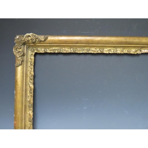 83 - A LATE 18TH / EARLY 19TH CENTURY GOLD FRAME WITH CORNER EMBELLISHMENTS, leaf design to inner edge, f... 