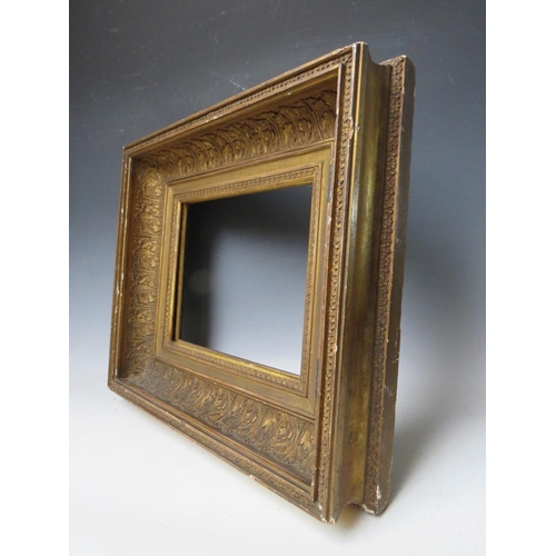 84 - AN 18TH CENTURY GOLD HINGED CABINET FRAME, with acanthus leaf design, frame W 11 cm, rebate 25 x 31 ... 