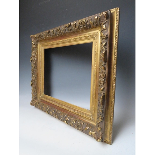 85 - A LATE 18TH / EARLY 19TH CENTURY DECORATIVE GOLD FRAME, with leaf design to outer edge, frame W 11 c... 