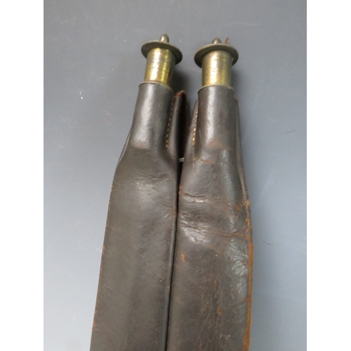 498 - A 19TH CENTURY LEATHER DOUBLE POWDER FLASK WITH STRAP, L 41 cm, W 9 cm