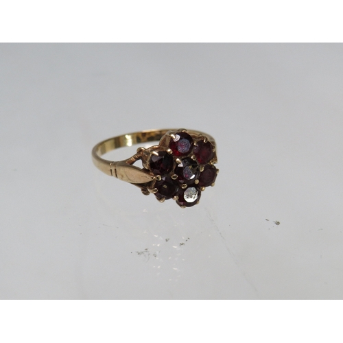 248 - A HALLMARKED 9CT GOLD FLORAL CLUSTER DRESS RING, set with garnet type gemstones, ring size R, approx... 