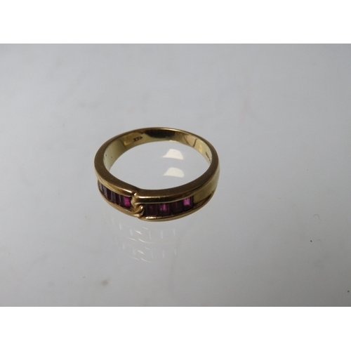 272 - AN 18CT GOLD GEMSET RING, of simple crossover design  with 8 baguette cut channel set ruby type gems... 