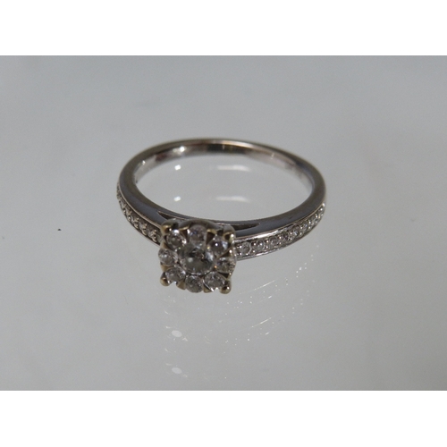 300 - A HALLMARKED 18CT GOLD DIAMOND CLUSTER RING, with diamond set shoulders. stamped DIA 0.50, approxima... 