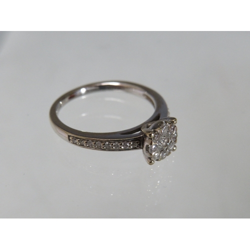 300 - A HALLMARKED 18CT GOLD DIAMOND CLUSTER RING, with diamond set shoulders. stamped DIA 0.50, approxima... 