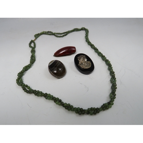 255 - A VINTAGE BANDED AGATE BROOCH, together with a double twisted strand spinach jade type bead necklace... 